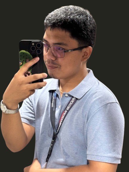 John Paul G. Manongsong wearing glasses and a light blue polo
